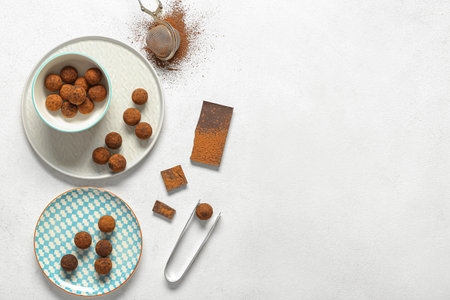 Plates with tasty chocolate truffles on white backgroundの写真素材