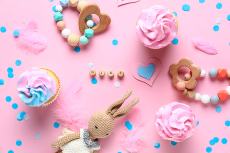 Delicious cupcakes, text GIRL and kid toys on pink background. Gender reveal party conceptの写真素材