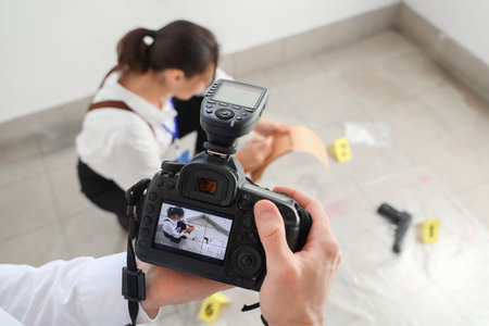 FBI agent with photo camera at crime scene, closeupの写真素材