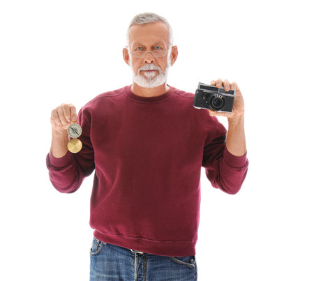 Senior man with camera and compass isolated on white backgroundの写真素材