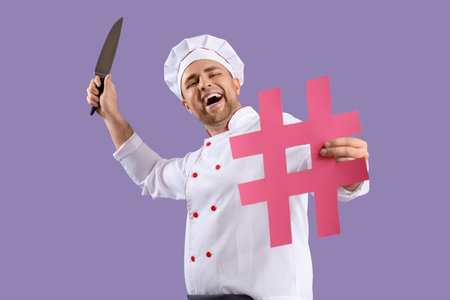 Male chef with hashtag and knife on lilac backgroundの写真素材