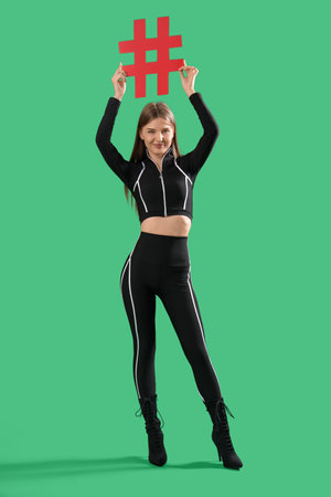 Beautiful grid girl with hashtag sign on green backgroundの写真素材