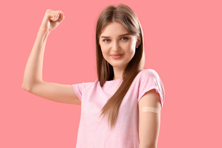 Young woman with applied medical patch on color backgroundの写真素材