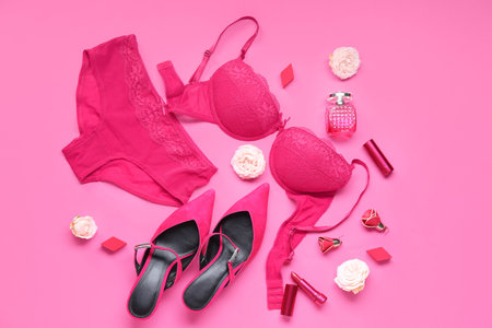 Composition with stylish female underwear, shoes and cosmetics on pink backgroundの写真素材