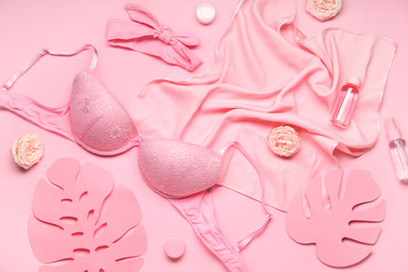 Composition with stylish female bra, accessories and cosmetics on pink backgroundの写真素材