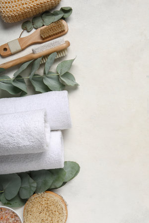 Composition with different spa accessories and eucalyptus branches on light backgroundの写真素材