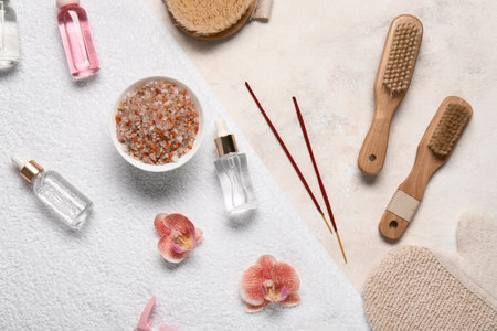 Composition with spa accessories, cosmetic products and flowers on light backgroundの写真素材