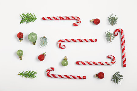 Candy canes with Christmas decorations on white backgroundの写真素材