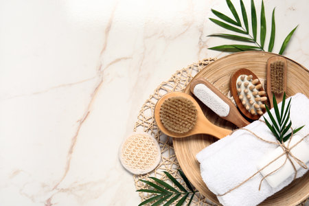 Composition with different bath supplies and palm leaves on light backgroundの写真素材
