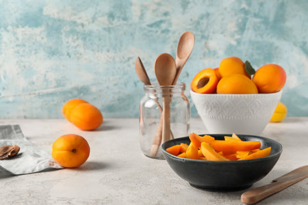 Bowl with pieces of sweet apricots on white tableの写真素材
