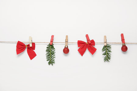 Beautiful composition with Christmas balls, fir branches and bows on white backgroundの写真素材