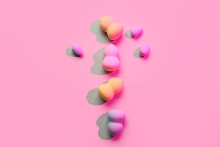 Different makeup sponges on pink backgroundの写真素材