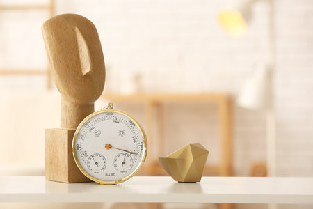Aneroid barometer and decor on table in room, closeupの写真素材