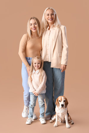 Happy family with cute dog on beige backgroundの写真素材