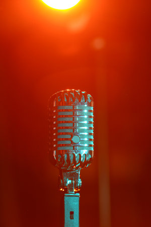 Retro microphone on dark red background, closeupの写真素材