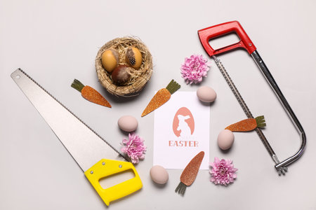 Composition with greeting card, gardening tools and Easter decor on gray background7