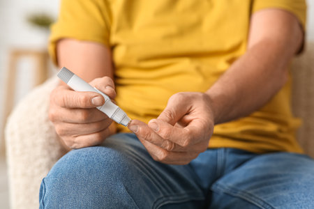 Senior man giving himself insulin injection at home, closeup. Diabetes conceptの写真素材