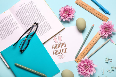Composition with greeting card, teacher's items and Easter decor on blue backgroundの写真素材