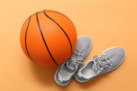 Basketball and gray trainers on orange backgroundの写真素材