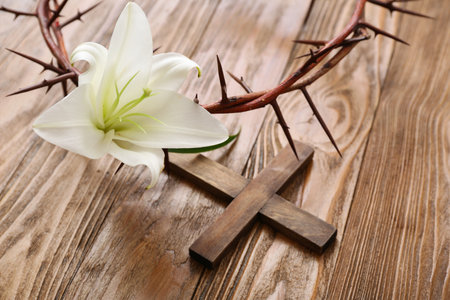 White lily, crown of thorns and cross on wooden background, closeupの写真素材