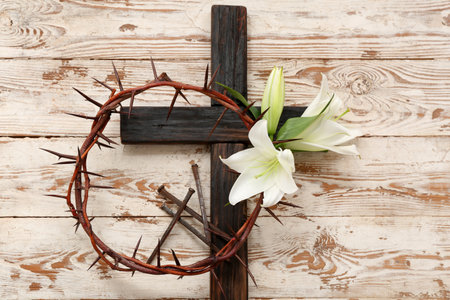 Cross, crown of thorns, white lilies and nails on wooden backgroundの写真素材