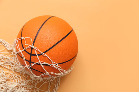 Basketball with net on orange background