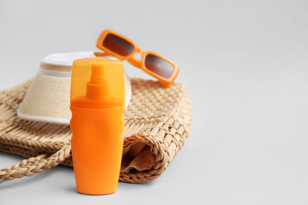Bottle of sunscreen cream and beach accessories on white backgroundの写真素材