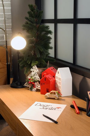 Letter to Santa on home office desk with Christmas tree and decorationsの写真素材