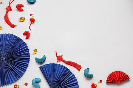 Composition with Chinese symbols and tasty fortune cookies on light background. New Year celebrationの写真素材