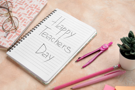 Notebooks with text HAPPY TEACHERS DAY, eyeglasses and different stationery on grunge pink backgroundの写真素材