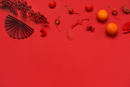 Composition with Chinese symbols, fortune cookies and tangerines on red background. New Year celebrationの写真素材
