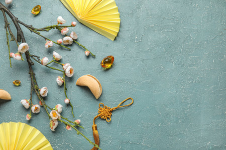 Composition with blooming sakura branch and Chinese symbols on color background. New Year celebrationの写真素材