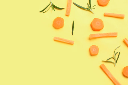 Slices of fresh carrots on yellow background