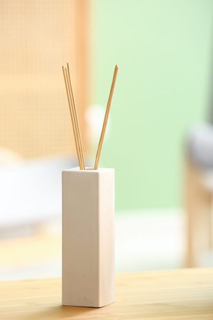 Bottle of reed diffuser on table, closeup
