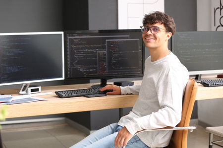 Male programmer working at table in officeの写真素材