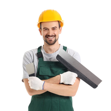 Male decorator with putty knives on white background