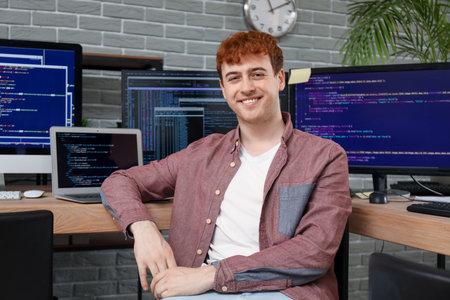 Male programmer working at table in office
