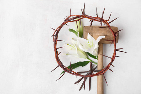 Crown of thorns, lilies, hammer and nails on white backgroundの写真素材