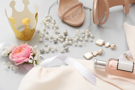 Female prom outfit with crown, perfume bottle and accessories on white backgroundの写真素材