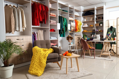 Interior of atelier with tailor's workplace, armchair and shelvesの写真素材