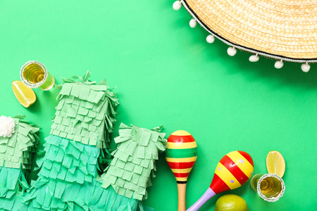 Composition with Mexican symbols and shots of tequila on green backgroundの写真素材