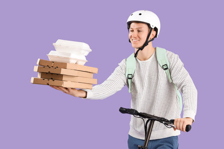 Male courier with pizza boxes and food containers riding kick scooter on lilac background