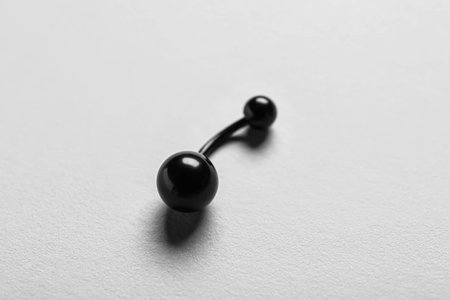 Belly button piercing ring on white background