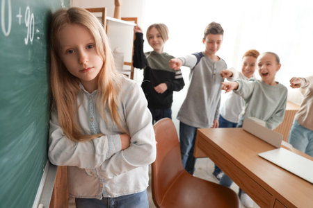 Bullied little girl during lesson in classroom