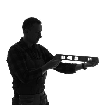 Silhouette of male worker with level on white background
