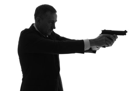 Silhouette of mature man with gun on white background