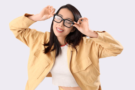Young Asian woman in eyeglasses on white backgroundの写真素材
