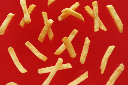 Tasty French fries on red backgroundの写真素材
