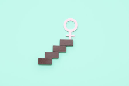 Female gender symbol and stairs on turquoise backgroundの写真素材