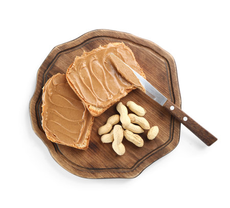 Wooden board of toasts with peanut butter and nuts on white background